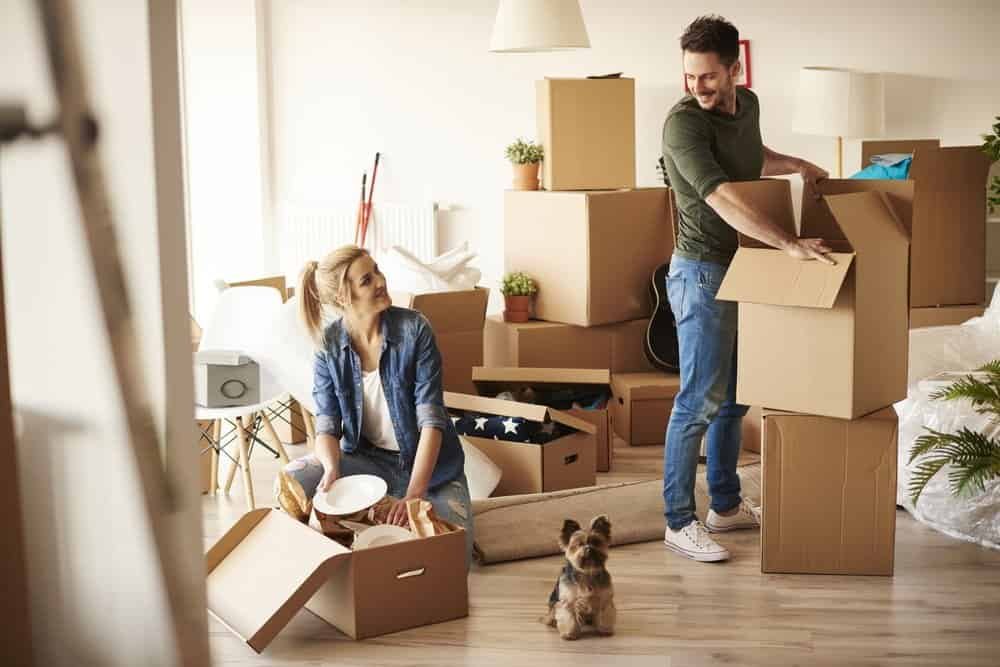 young homeowners unpacking goods in their new place