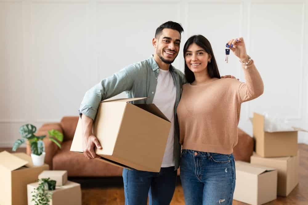New home owners holding up their keys.